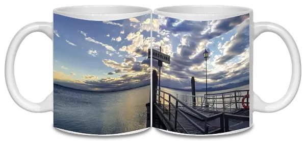 Sunset over pier at lake Garda in Bardolino Italy. Panoramic view on sunset over pier