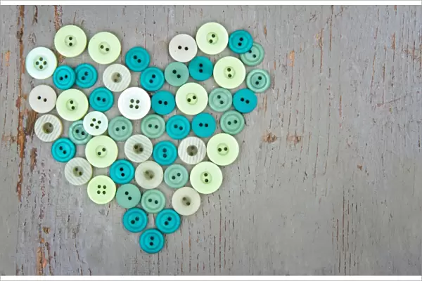 Green buttons on wooden background