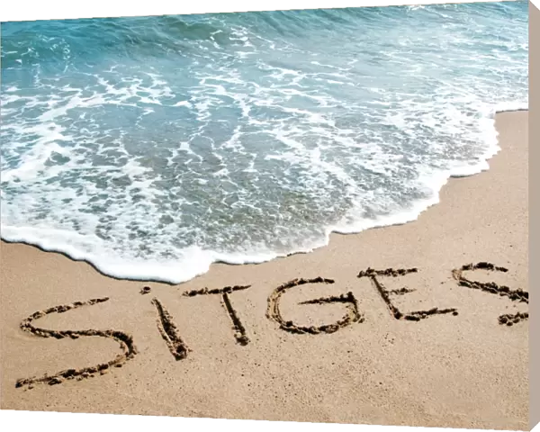 sitges written on the sand of a beach