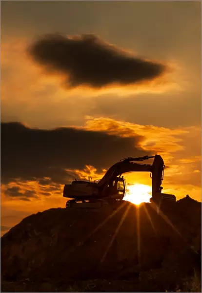 skyline excavator with colored sunset