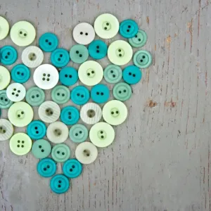 Green buttons on wooden background Green buttons on wooden background