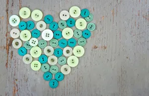 Green buttons on wooden background