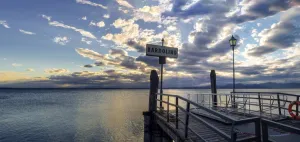 Sunset over pier at lake Garda in Bardolino Italy. Panoramic view on sunset over pier