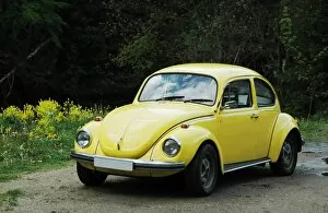 Trending: yellow old VW Beetle 1302 on sandy ground